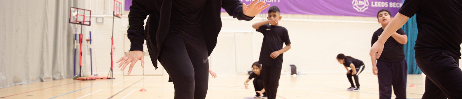 11 Female coach running with players